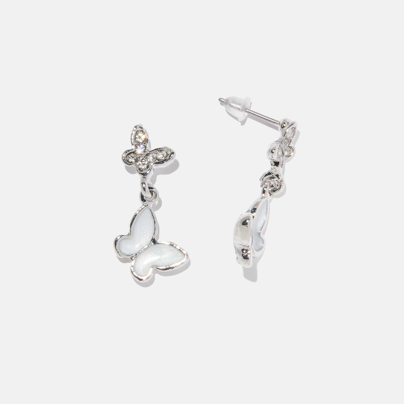 Silverfärgade örhängen - vita hängande fjärilar